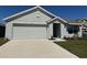 Charming single-story home features a two-car garage, landscaped front yard, and inviting entrance at 11517 Timber Grove Ln, Brooksville, FL 34613