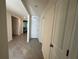 Bright hallway with tile flooring leads to the living spaces and bedrooms at 11517 Timber Grove Ln, Brooksville, FL 34613