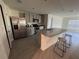 Modern kitchen with stainless steel appliances, granite countertops, and a breakfast bar at 11517 Timber Grove Ln, Brooksville, FL 34613