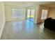 Spacious living area with tile floors, sliding glass doors to the patio, and a bright window at 11517 Timber Grove Ln, Brooksville, FL 34613
