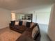 Comfortable living room with a large sectional sofa, seamlessly connecting to the kitchen area at 11517 Timber Grove Ln, Brooksville, FL 34613