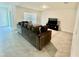 Comfortable living room with plush sofa, media console, and a bright window offering natural light at 11517 Timber Grove Ln, Brooksville, FL 34613