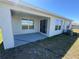 Covered patio with sliding door access, perfect for outdoor relaxation and entertaining with green grass at 11517 Timber Grove Ln, Brooksville, FL 34613