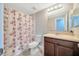 Traditional bathroom featuring a shower/tub combination, a wood vanity, and neutral colors at 1208 Briarpark Way, Valrico, FL 33596