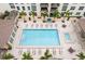 Aerial view of a luxurious pool with lounge chairs, tables and beautiful tile design at 1227 E Madison St # 1004, Tampa, FL 33602