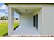 Covered back porch with a view of the spacious, grassy backyard at 12823 Wanderlust Pl, Parrish, FL 34219