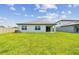 Large backyard with a spacious lawn and a modern home exterior at 12823 Wanderlust Pl, Parrish, FL 34219