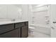 Clean bathroom with dark wood cabinets and a shower-tub combo at 12823 Wanderlust Pl, Parrish, FL 34219