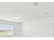 Minimalist bedroom with neutral walls, large windows, and plenty of natural light at 12823 Wanderlust Pl, Parrish, FL 34219
