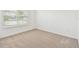 Bright bedroom with carpet flooring and a large window with blinds at 12823 Wanderlust Pl, Parrish, FL 34219