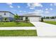 Charming single-story home features a well-manicured lawn, driveway, and attached two-car garage at 12823 Wanderlust Pl, Parrish, FL 34219
