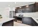 Stylish kitchen with dark cabinetry, stainless steel appliances, quartz countertops, and recessed lighting at 12823 Wanderlust Pl, Parrish, FL 34219