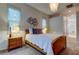 Well-lit bedroom with a comfortable bed, soft carpet, and stylish decor at 14115 Lincolnshire Ct, Tampa, FL 33626