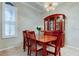 Elegant dining room with wood table, seating for six, and stylish chandelier lighting at 14115 Lincolnshire Ct, Tampa, FL 33626