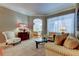 Cozy living room featuring neutral tones, plush seating, and abundant natural light at 14115 Lincolnshire Ct, Tampa, FL 33626