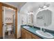 Well-lit bathroom with double sinks, vanity with wood cabinets, and a separate water closet at 14206 Walden Sheffield Rd, Dover, FL 33527
