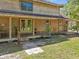 Close up of a rustic log cabin home with covered porch and a well-manicured lawn at 14206 Walden Sheffield Rd, Dover, FL 33527