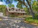 Beautiful log cabin home with a covered front porch and well-manicured front yard at 14206 Walden Sheffield Rd, Dover, FL 33527