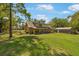 Charming log cabin home with a well-maintained lawn and a rustic outbuilding at 14206 Walden Sheffield Rd, Dover, FL 33527