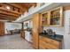 Open kitchen with natural wood cabinets, modern appliances, and a dining area perfect for Gathering meals at 14206 Walden Sheffield Rd, Dover, FL 33527