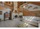 Spacious living room with a stone fireplace, wood beams, and staircase, creating a cozy and inviting atmosphere at 14206 Walden Sheffield Rd, Dover, FL 33527
