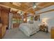 Comfortable main bedroom with wood walls, exposed beams, carpeted floors, and large windows at 14206 Walden Sheffield Rd, Dover, FL 33527