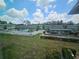 Scenic view of the community's pool area with green lawn, buildings, and blue skies at 1433 S Belcher Rd # A12, Clearwater, FL 33764