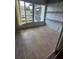 A well-lit sun room with a view of the outside, tile floors, and open shelving at 1433 S Belcher Rd # A12, Clearwater, FL 33764