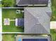 An aerial view of a fenced backyard showing a pergola, patio, lawn, and various outdoor features at 15410 Fire Rock Pl, Ruskin, FL 33573