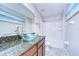 Charming bathroom featuring granite countertop and stylish glass bowl sink at 15410 Fire Rock Pl, Ruskin, FL 33573