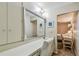 The bathroom has a vanity with a mirror and storage, adjacent to the bedroom at 1601 43Rd N St # 140, St Petersburg, FL 33713