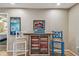 Dining area featuring a rustic bar, a decorative mirror, colorful artwork, and bar stool seating with pops of blue at 1601 43Rd N St # 140, St Petersburg, FL 33713