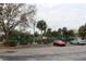 Outdoor tennis courts behind parking lot with multiple palm trees at 18415 Bridle Club Dr, Tampa, FL 33647