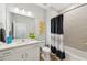 Bathroom featuring a vanity with a white countertop, a toilet, and a shower with a modern shower curtain at 1848 Sunset Preserve Way, Port Charlotte, FL 33953