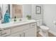 Well-lit bathroom featuring a white vanity, modern fixtures, and tiled floors at 1848 Sunset Preserve Way, Port Charlotte, FL 33953