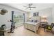 Bright bedroom offering a ceiling fan, wood-look flooring, and an exercise bike at 1848 Sunset Preserve Way, Port Charlotte, FL 33953