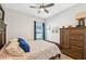 Comfortable bedroom featuring a ceiling fan, wood-look floors, and tasteful decor at 1848 Sunset Preserve Way, Port Charlotte, FL 33953