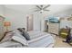 Serene bedroom featuring stylish decor, wood-look floors, and a large dresser at 1848 Sunset Preserve Way, Port Charlotte, FL 33953