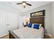 Cozy bedroom with a ceiling fan, wood-look floors, and a comfortable bed at 1848 Sunset Preserve Way, Port Charlotte, FL 33953