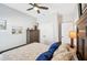 Charming bedroom showcasing wood-look floors, ceiling fan, and a wardrobe chest at 1848 Sunset Preserve Way, Port Charlotte, FL 33953