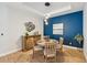 Dining area with modern lighting and a decorative blue accent wall at 1848 Sunset Preserve Way, Port Charlotte, FL 33953