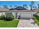 Charming single-Gathering home featuring a two-car garage, lush lawn and driveway at 1848 Sunset Preserve Way, Port Charlotte, FL 33953