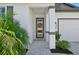 Inviting front porch with decorative accents and a view of the manicured landscaping at 1848 Sunset Preserve Way, Port Charlotte, FL 33953