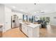 Open kitchen with white cabinets, stainless appliances, and a center island at 1848 Sunset Preserve Way, Port Charlotte, FL 33953