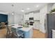 Modern kitchen with stainless appliances, white cabinetry, and an island with seating for casual dining at 1848 Sunset Preserve Way, Port Charlotte, FL 33953