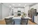 Modern kitchen with stainless appliances, white cabinetry, and an island with seating for casual dining at 1848 Sunset Preserve Way, Port Charlotte, FL 33953