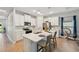 Bright kitchen features white cabinets, stainless steel appliances, and a center island with bar seating at 1848 Sunset Preserve Way, Port Charlotte, FL 33953