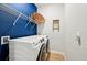 Functional laundry room with modern washer and dryer and ample storage shelving at 1848 Sunset Preserve Way, Port Charlotte, FL 33953