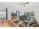 Comfortable living room with a ceiling fan, large window and leather furniture at 1848 Sunset Preserve Way, Port Charlotte, FL 33953