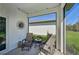 A covered patio featuring two lounge chairs with a view of the lawn at 1848 Sunset Preserve Way, Port Charlotte, FL 33953